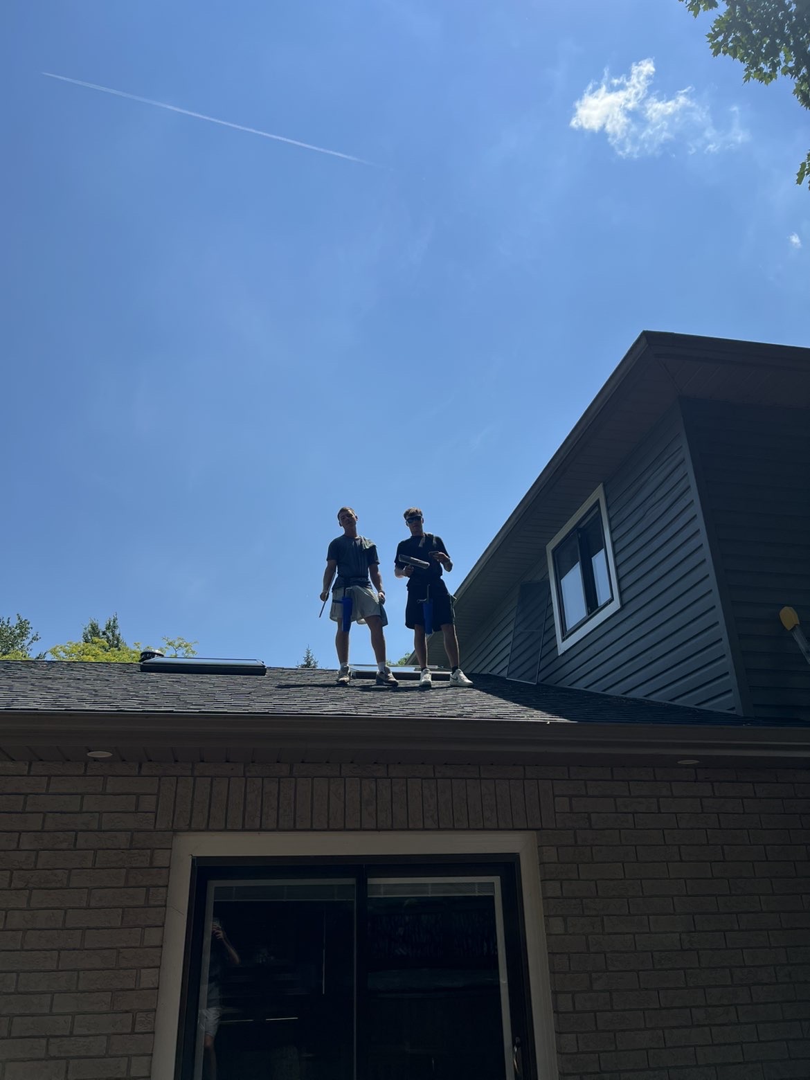 Tyler and James, owners of Altitude PMG, on a residential rooftop